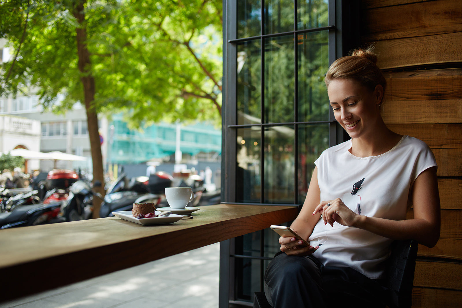 Frau am Smartphone im Café